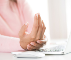 photo illustration of laptop user with wrist pain
