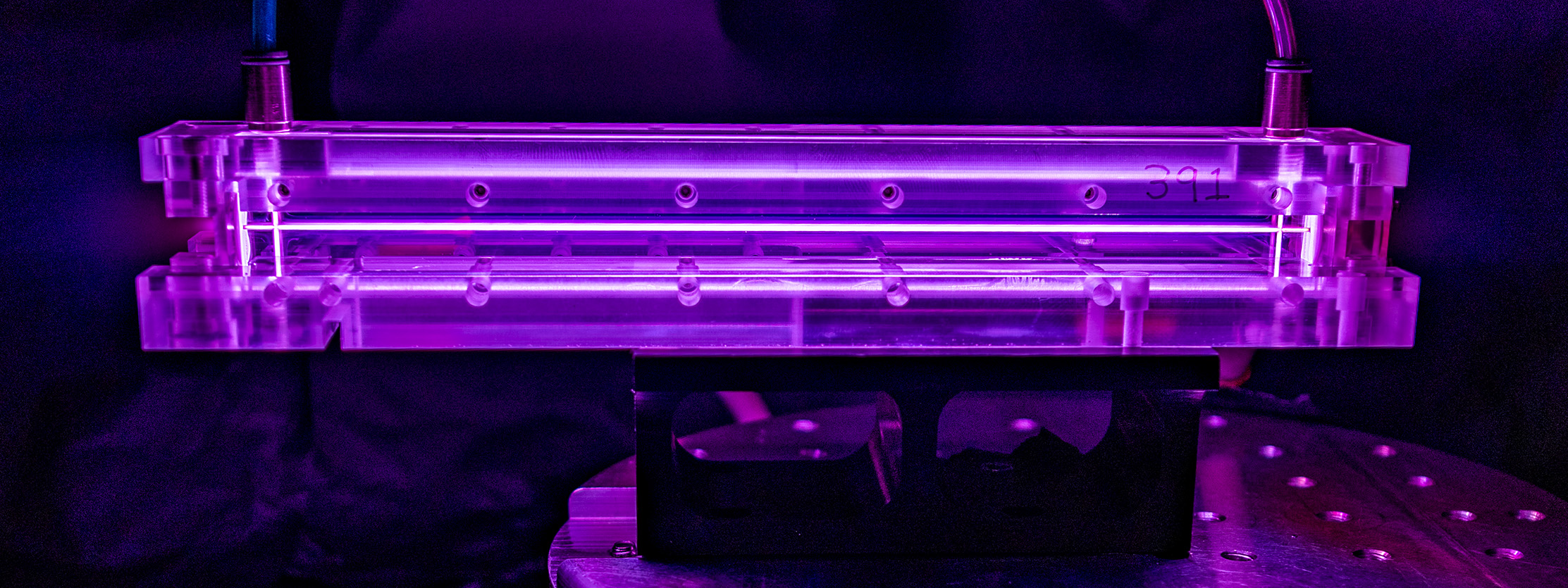 The plasma-filled capillary at the heart of a laser-plasma accelerator glows purple