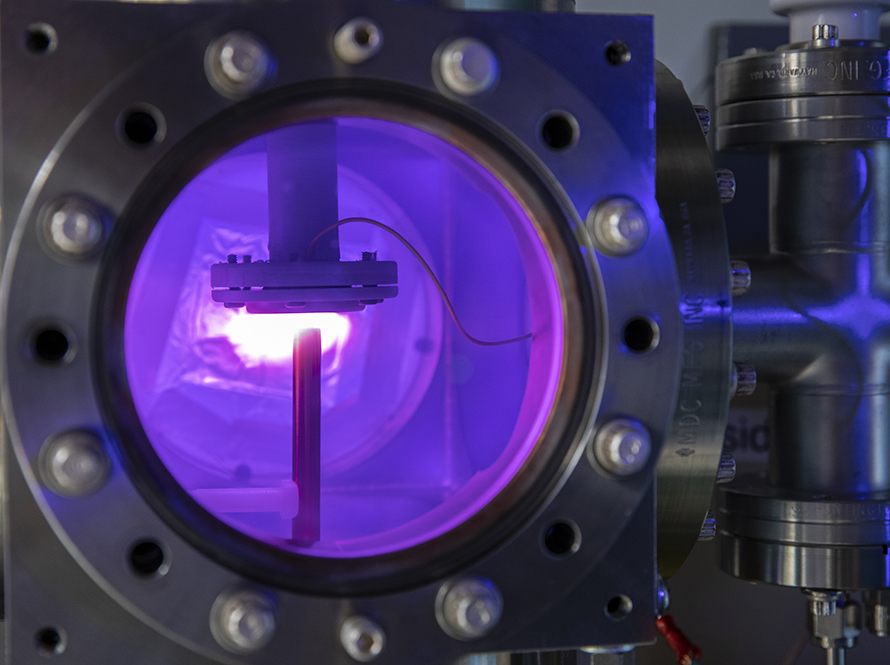 Plasma glows purple in a low temperature plasma chamber 