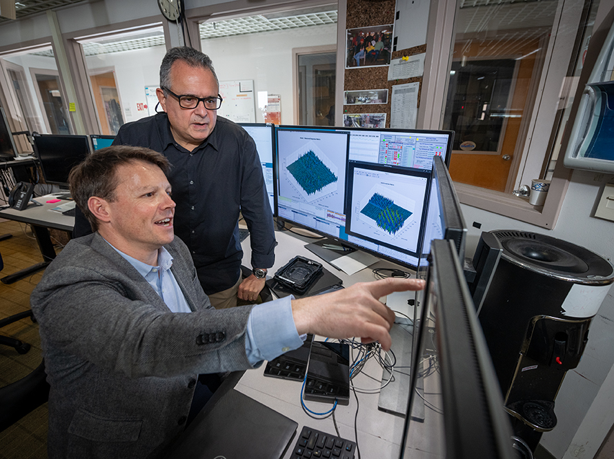Two researchers work in front of monitors at Advanced Light Source