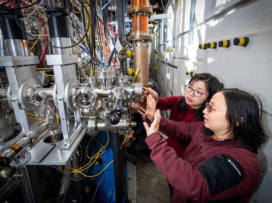 Two researchers work at an electron beamline for the HiRES apparatus.