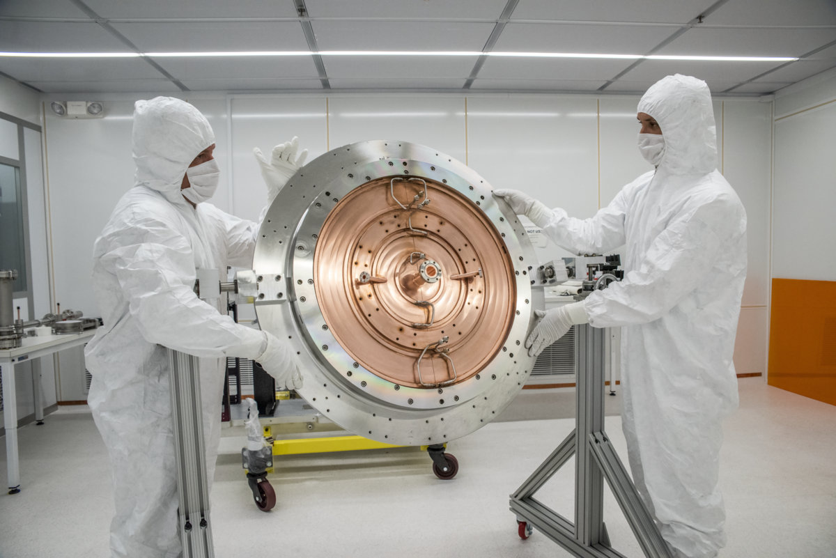 Photo - Berkeley Lab Mechanical Engineers Joe Wallig, left, and Brian Reynolds work on the final assembly of the LCLS-II injector gun in a specially designed clean room at Berkeley Lab in August. (Credit: Marilyn Chung/Berkeley Lab)