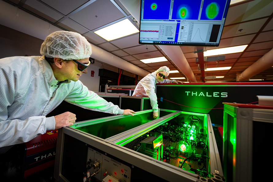 Two scientists make adjustments to a laser beamline