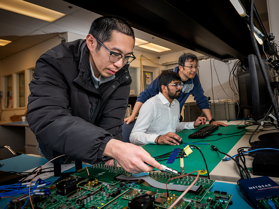 Researcher inspects circuit board